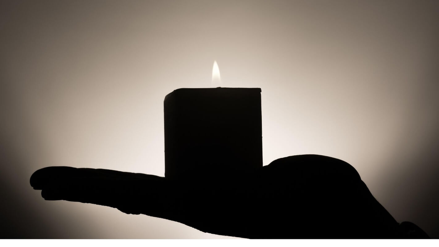 Holding Space, Holding Light" Silhouette of a hand holding a lit candle — symbolizing remembrance, grief, and healing.”</p>
<p>