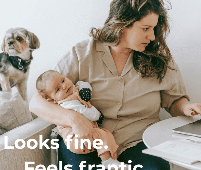 Stressed mother with baby working on laptop, representing high-functioning anxiety in women — online anxiety therapy in Seattle.
