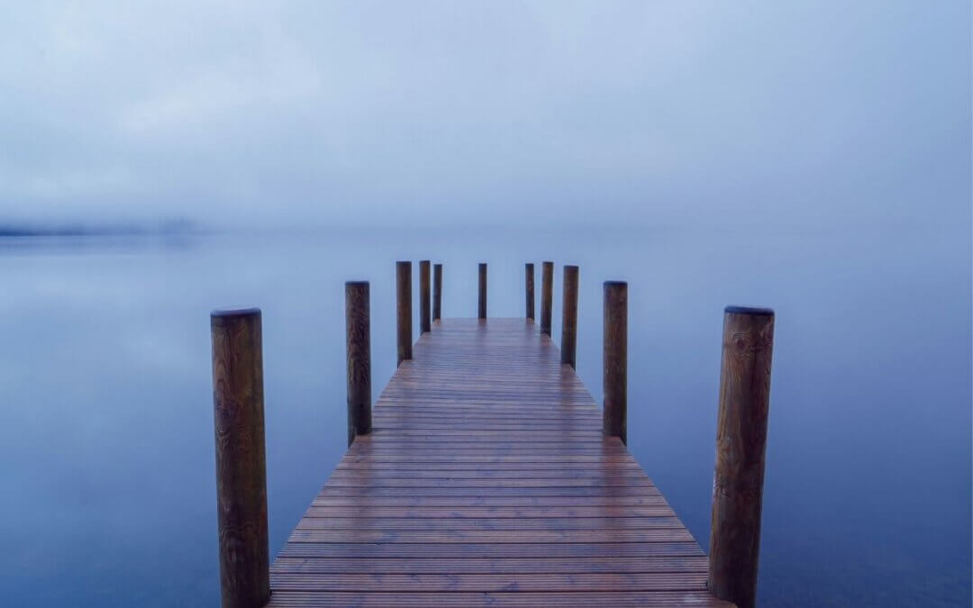 Foggy dock over still water representing anxiety, meditation struggles, and emotional overwhelm